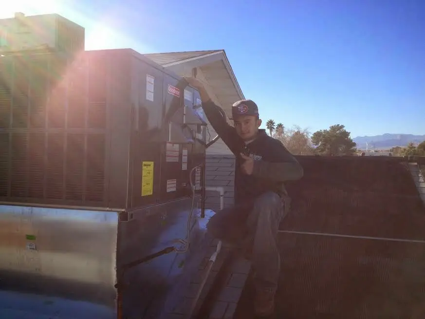 HVAC technician performing Heat Pump Repair on a rooftop unit in Fruitridge Pocket